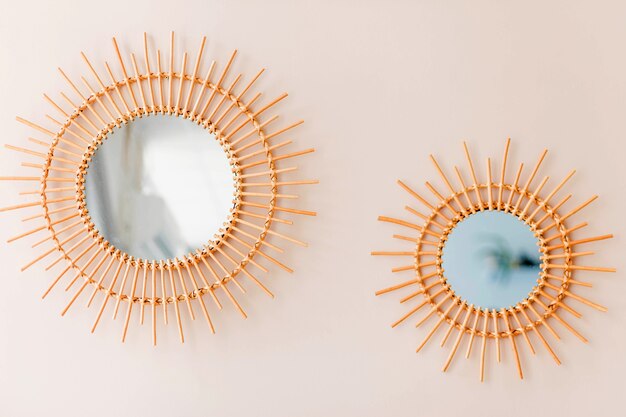 Two round mirrors as a decor hang on a round wall. Horizontal photo