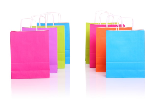 two rows of colorful shopping bags over white