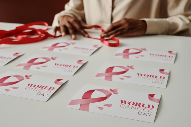 Two rows of handmade postcards being prepared by young black woman