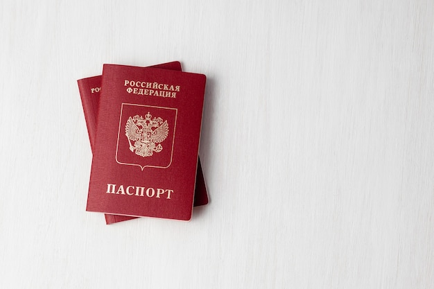 Two Russian passports on white wall