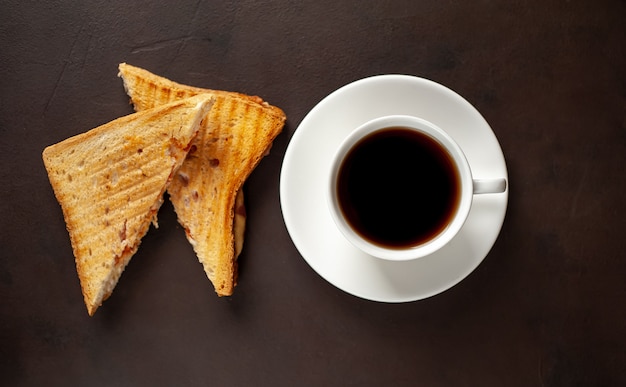 two sandwiches and coffee on a stone background