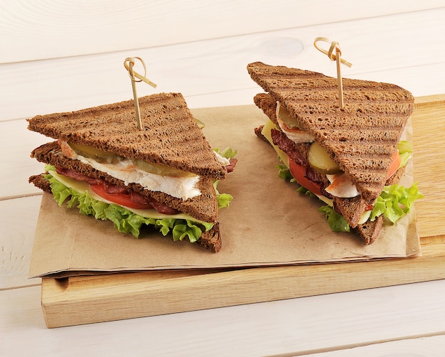 Two sandwiches from triangular pieces of bread with chicken breast