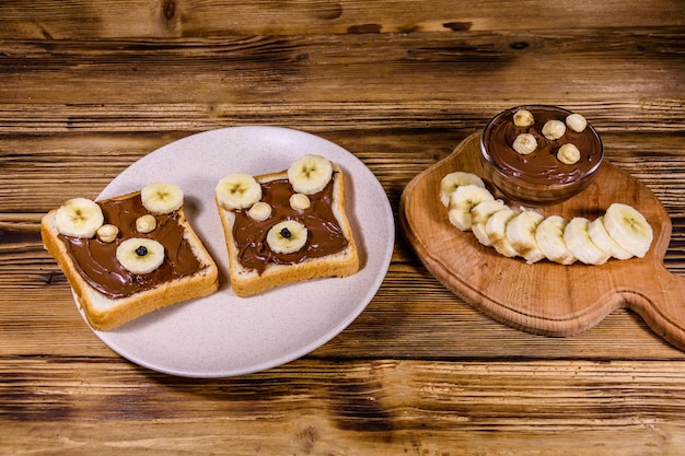 Two sandwiches with chocolate spread on a plate. Sandwich like a bear muzzle