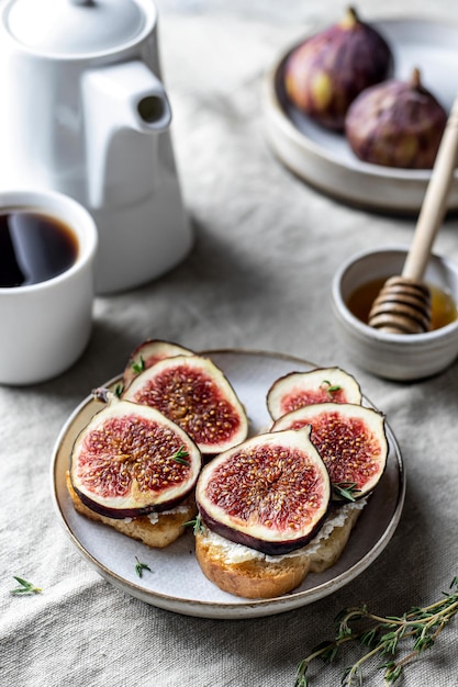 Two sandwiches with figs thyme on textured background Breakfast composition