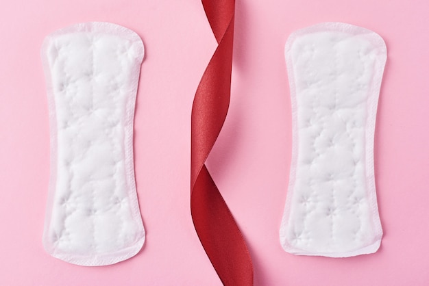 Photo two sanitary pads and red ribbon