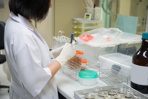 Two scientist mix chemicals make experiment in the labmixture\
laced with samples into test tubesthailand scientist working in the\
lab