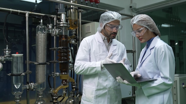 Two scientist in professional uniform working in laboratory for chemical and biomedical experiment