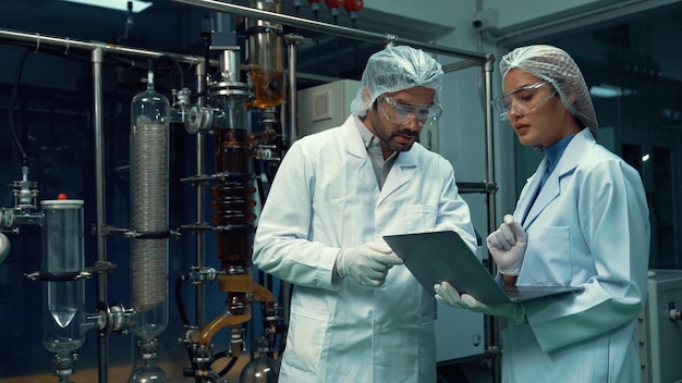 Two scientist in professional uniform working in laboratory