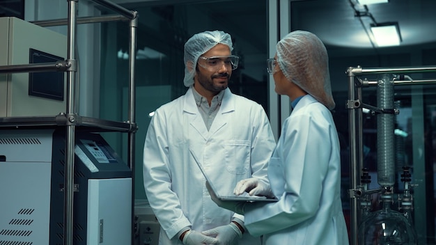 Two scientist in professional uniform working in laboratory