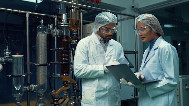 Two scientist in professional uniform working in laboratory