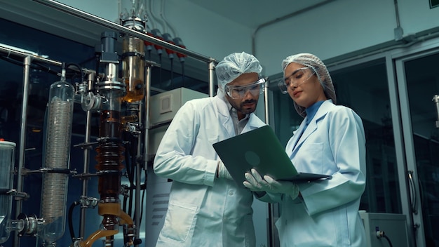Two scientist in professional uniform working in laboratory