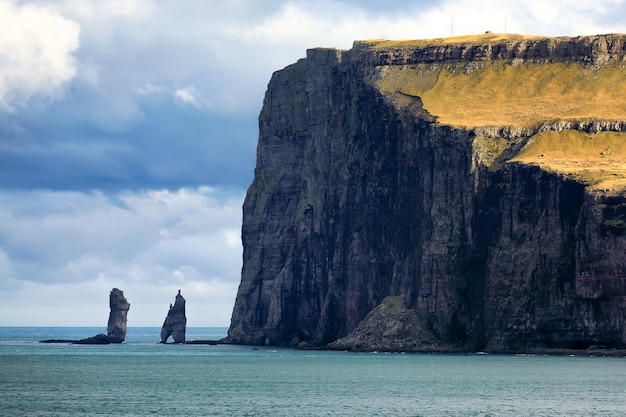 Two sea stacks Risin and Kellingin on Faroe Islands and Atlantic ocean