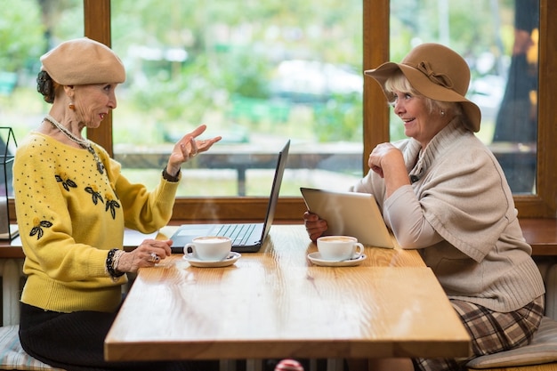 Two senior women in cafe