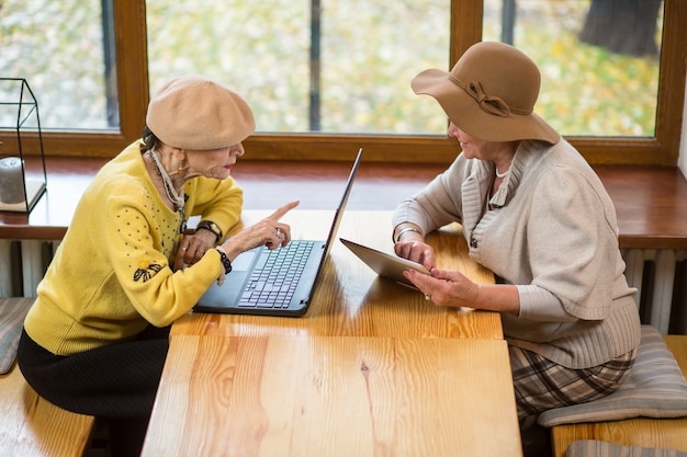 Two senior women and laptop