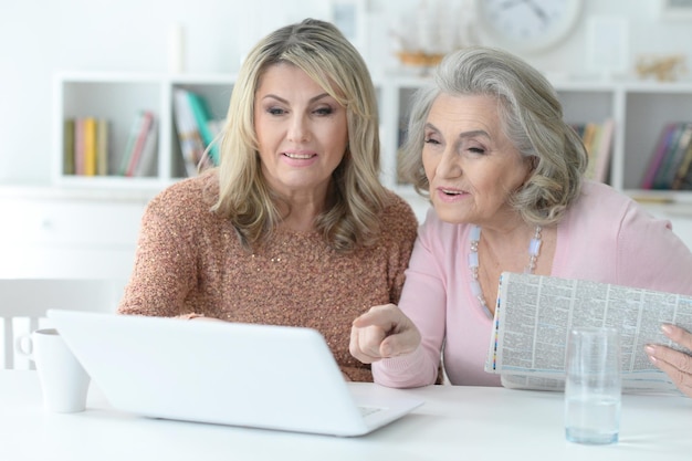 Two  Senior women using laptop at home