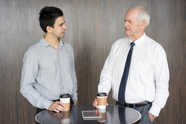 Two Serious Businessmen Arguing at Office Cafe