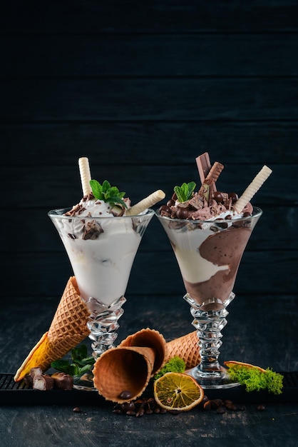 Two servings of ice cream On a black wooden background Copy space