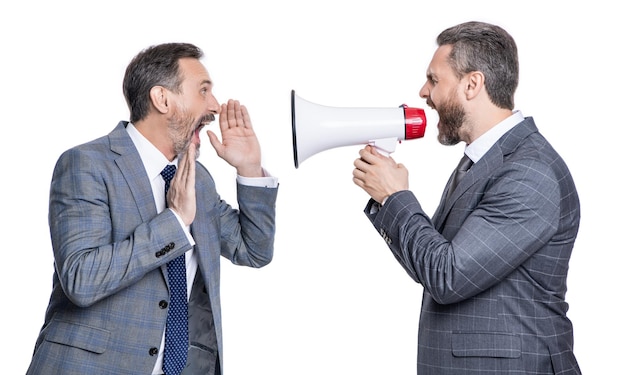 Two shocked businessmen shouting in loudspeaker businessmen shouting in loudspeaker