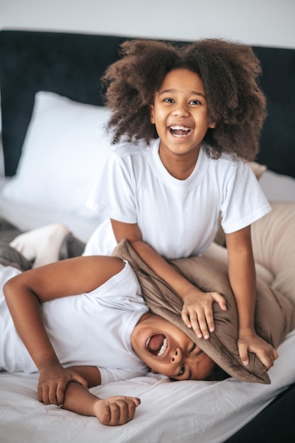 Two siblings playing together and looking excited