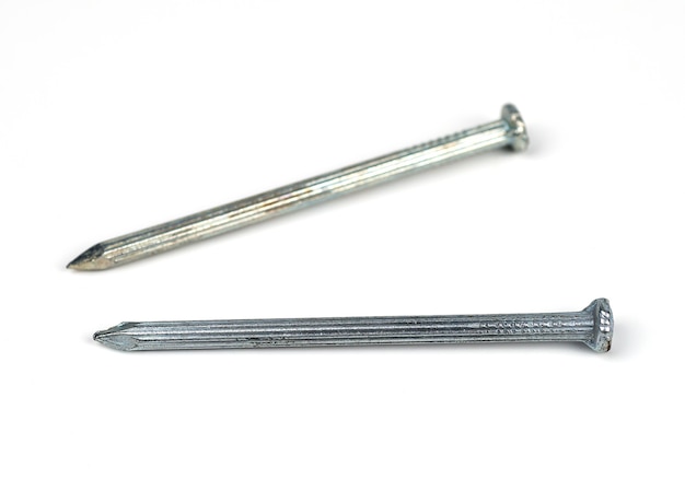 Two silver concrete nails on a white background