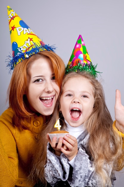 Two sisters four and eighteen years old at birthday. 