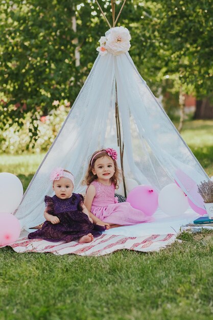 two sisters having fun in garden