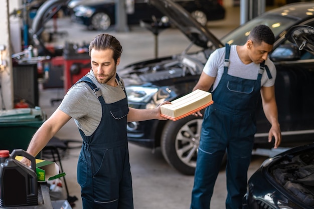 Two skilled mechanics fixing the customer vehicle