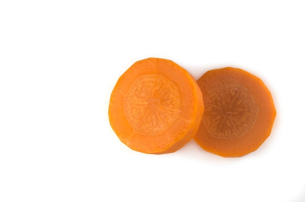 Два ломтика свежей оранжевой моркови на белом фоне