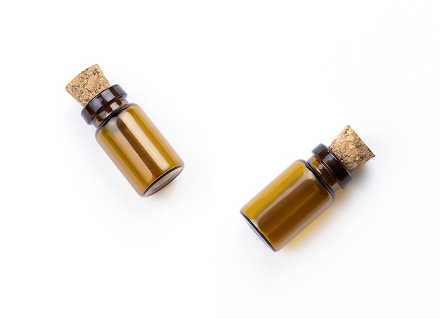 Two small bottles of corks on a white background