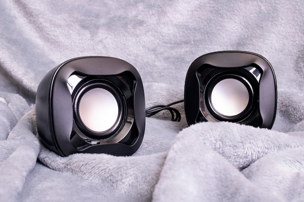 Two small speakers on a gray background