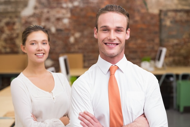 Two smiling business colleagues in office