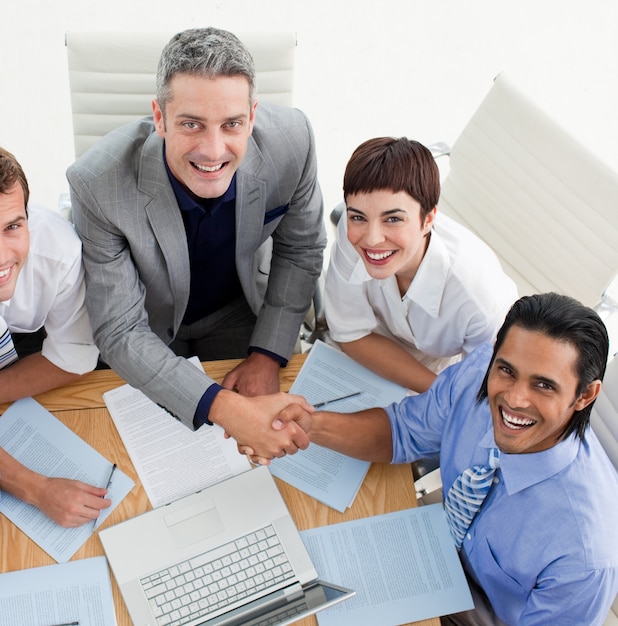 Two smiling business people greeting each other 