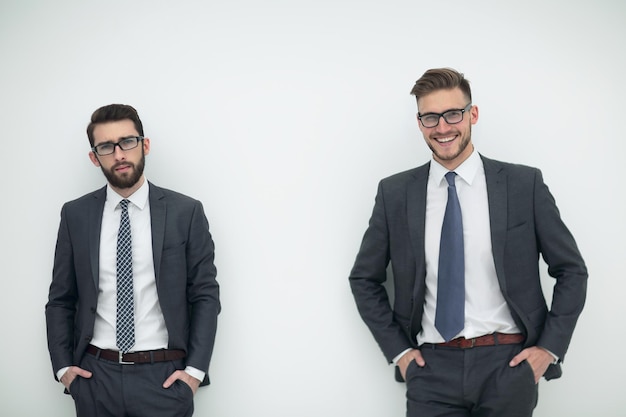 Two smiling businessmen isolated in the light photo with copy space