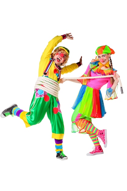 Two smiling clowns is playing a rope isolated over a white background