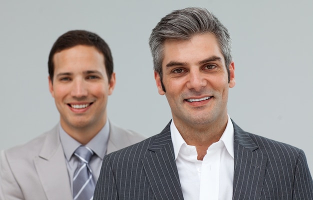 Two smiling co-workers standing in a row