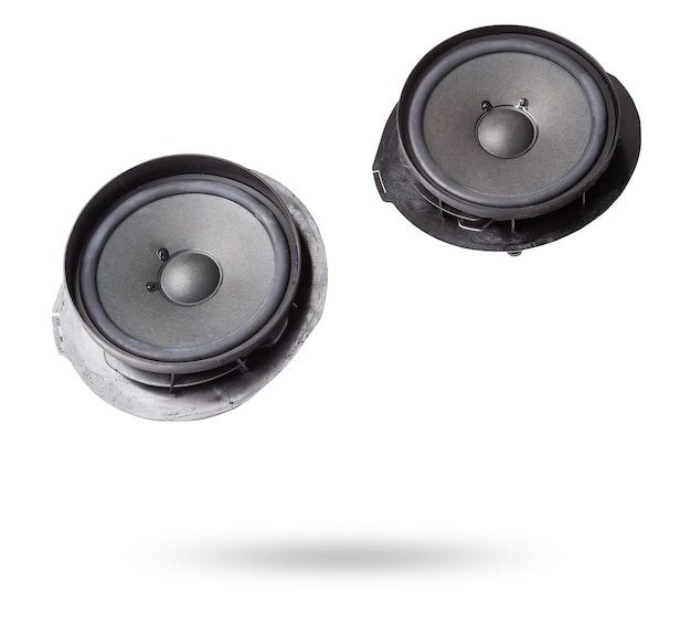 Two speakers of an acoustic system an audio for playing music in a car interior on a white isolated background in a photo studio Spare parts for auto repair in a workshop or for sale for tuning