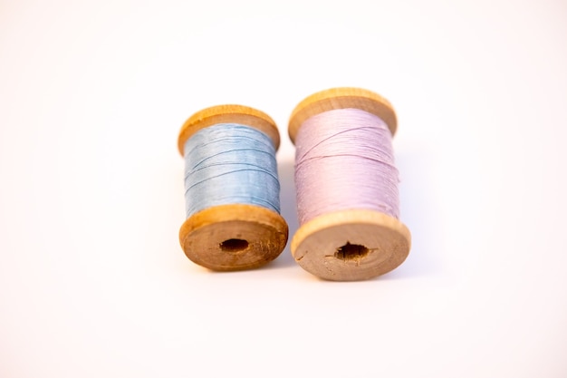 Two spools of thread on a white background