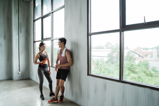 Two sport couple enjoy talking during workout