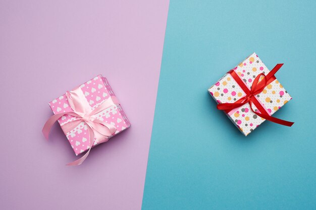 Two square cardboard boxes with tied ribbons