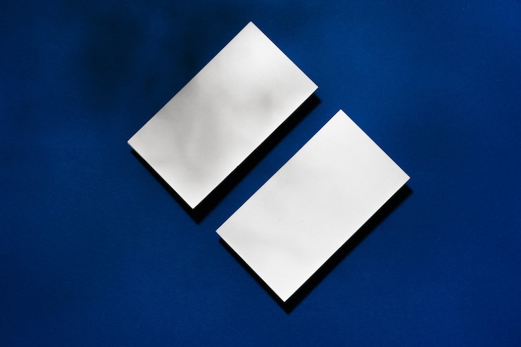 Photo two stacks of blank businesscards on blue surface