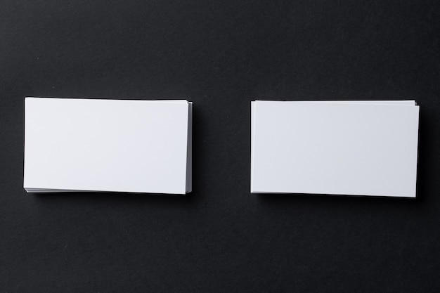 Two stacks of business cards on black background