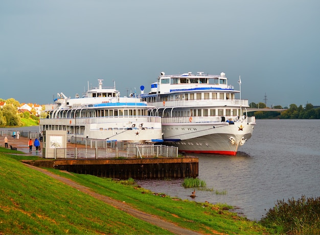 Two steamships near the river beach background