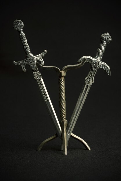 Photo two steel swords letter opener on black background