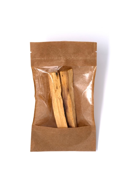 Two sticks of Palo Santo tree in craft package against white background