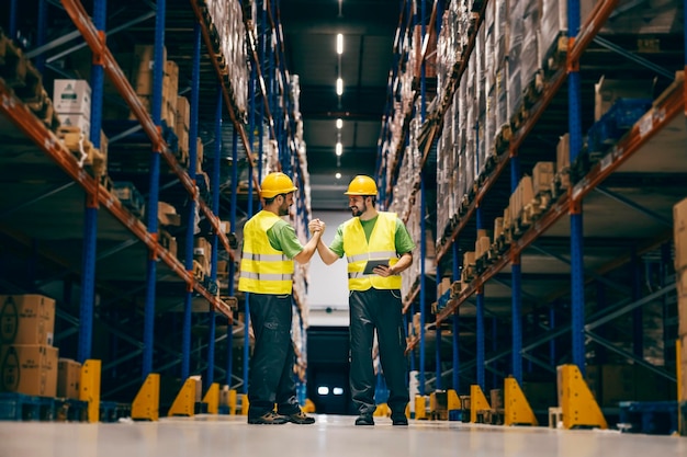 Two storage workers having bro handshake