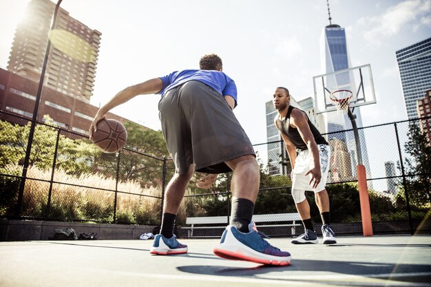 Two street basketball players playing hard on the court