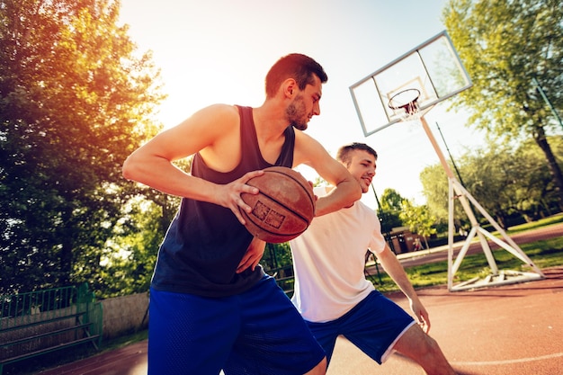 Two street basketball players playing one on one. they are making a good action and guarding the ball