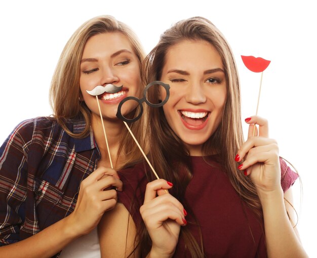 Photo two stylish sexy hipster girls best friends ready for party over white background