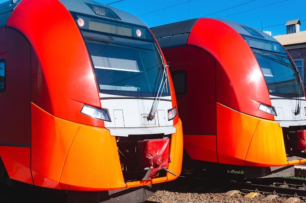 Two suburban trains stand at the station