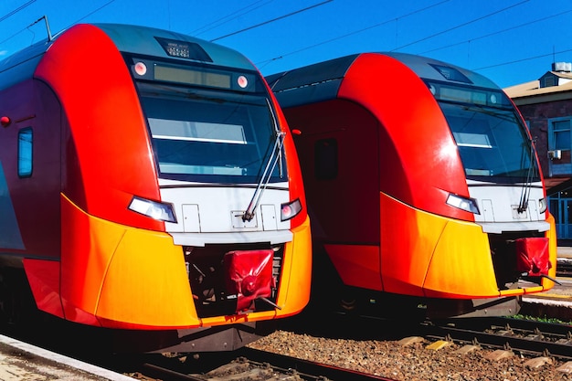 Two suburban trains stand at the station